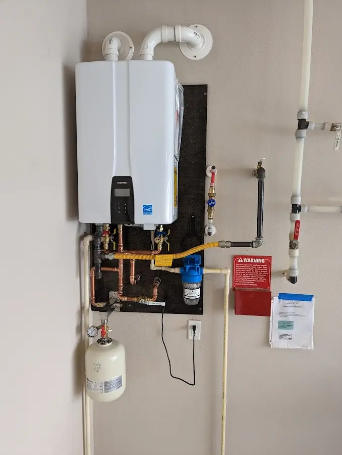 Professional plumber installing copper piping in a Vacaville home